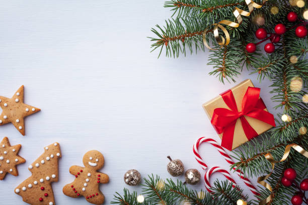 istock Beautiful composition on white background with golden Christmas gift boxes, fir tree, Christmas cookies and holiday decoration. Top view. 1180973507