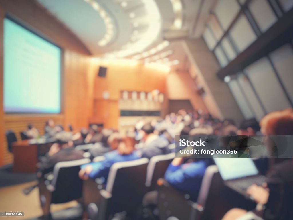 Blur of auditorium room use for present meeting background. Blur of auditorium room use for present meeting background Conference - Event Stock Photo