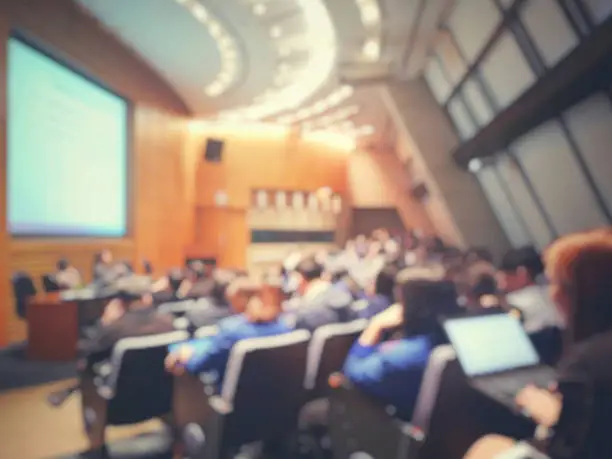 Photo of Blur of auditorium room use for present meeting background.