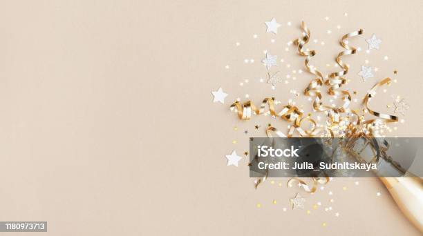 Celebration Background With Golden Champagne Bottle Confetti Stars And Party Streamers Christmas Birthday Or Wedding Concept Flat Lay Stock Photo - Download Image Now