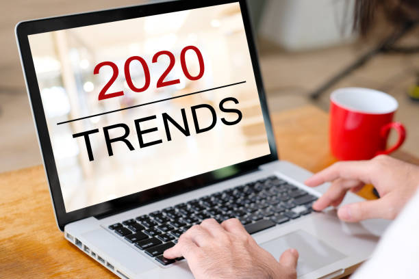istock 2020 digital trends, Man hand tying laptop computer with 2020 trends on screen background, digital marketing, business and technology concept 1180974048