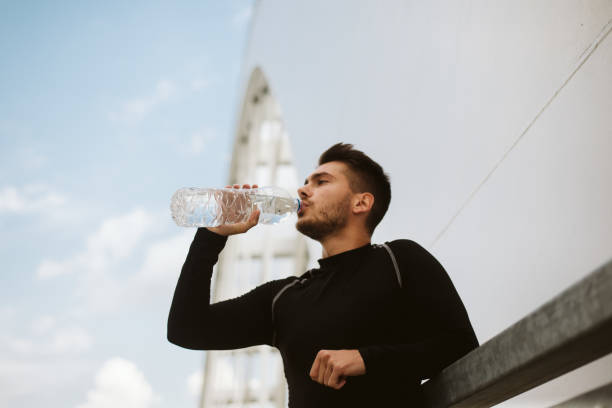istock Photo of an athletic man stretching after exercise. 1180974246
