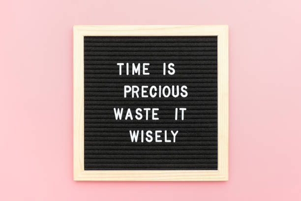 istock Time is precious waste it wisely. Motivational quote on letterboard on pink background. Top view Flat lay Copy space Concept inspirational quote of the day 1180975649