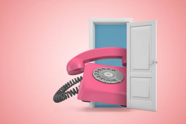 istock 3d rendering of huge pink retro landline phone emerging from open door on pink gradient copyspace background. 1180975839