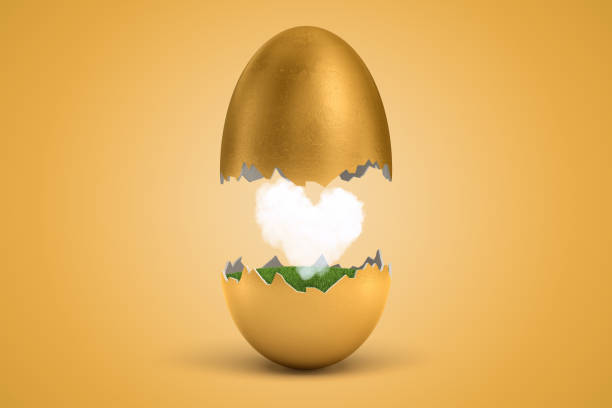 istock 3d rendering of gold egg cracked in two, upper half levitating in air, lower on ground, with small white heart-shaped cloud between two halves. 1180976138