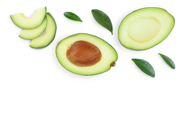 istock avocado and slices decorated with green leaves isolated on white background with copy space for your text. Top view. Flat lay 1180978115