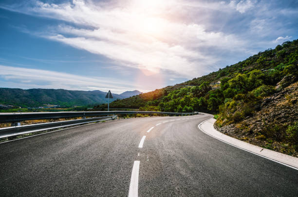 istock Empty long road on a sunny summer day at bright sunset 1180978416