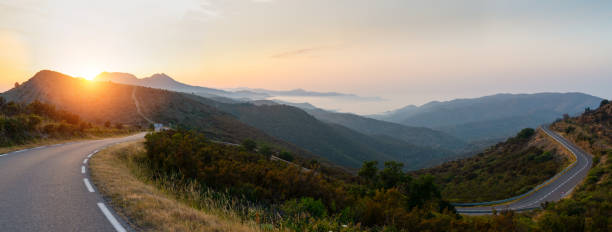 istock Empty long road on a sunny summer day at bright sunset 1180978936