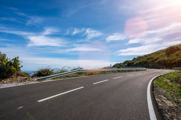 istock Empty long road on a sunny summer day at bright sunset 1180978954