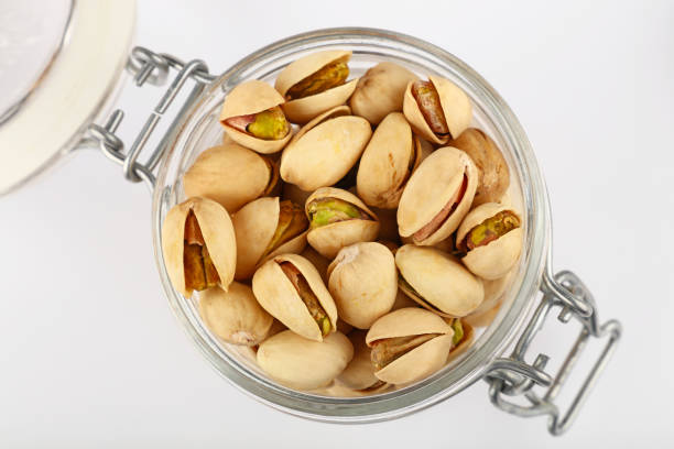 istock Fresh roasted pistachio nuts in glass jar 1180979152
