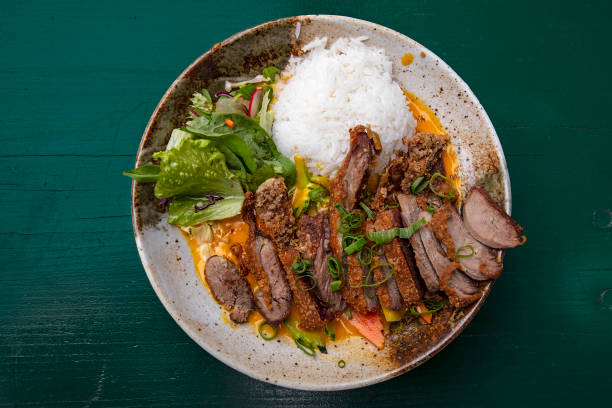 istock Peking duck curry with rice and salad 1180979158