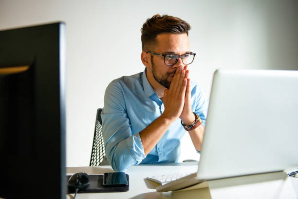 istock Young man sitting in his office 1180980613