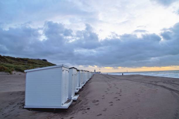 istock Little white beach cabins on the deserted beach in autumn 1180980813