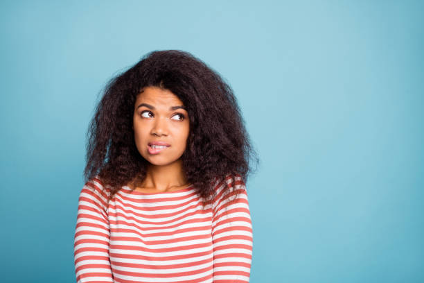 I'm so sorry. Photo of pretty dark skin lady looking empty space with guilty eyes biting lips apologizing wear casual clothes isolated pastel blue color background I'm so sorry. Photo of pretty dark skin lady looking empty space with guilty eyes, biting lips apologizing wear casual clothes isolated pastel blue color background guilty stock pictures, royalty-free photos & images