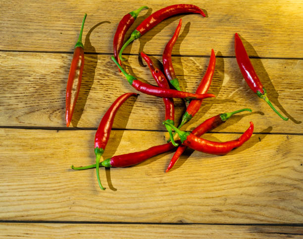 istock Red chili peppers on a wooden board. 1180983072