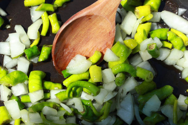 onions and peppers are roasted in the pan