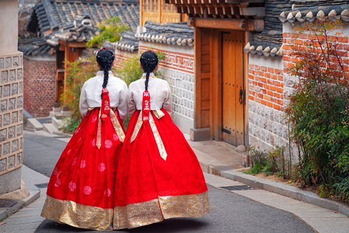 Korean lady in Hanbok or Korea dress and walk in an ancient town in seoul, Seoul city, South Korea.