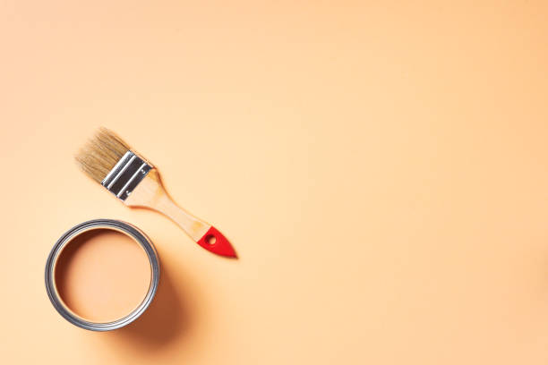 istock Paint brush and open paint can with on pastel background. Top view, copy space. Appartment renovation, repair, building and home design concept. 1180990093