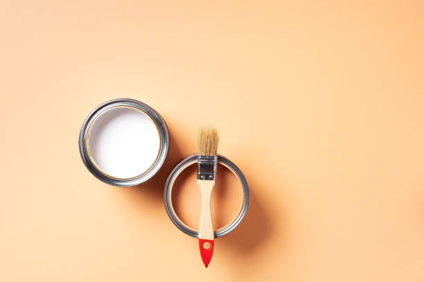 istock Paint brush and open paint can with on pastel background. Top view, copy space. Appartment renovation, repair, building and home design concept. 1180990098