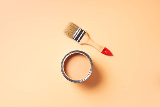istock Paint brush and open paint can with on pastel background. Top view, copy space. Appartment renovation, repair, building and home design concept. 1180990109