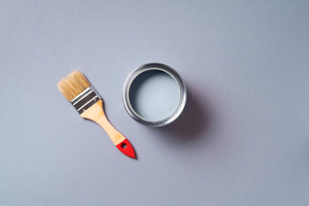 istock Brush and open paint can with on pastel background. Top view, copy space. Appartment renovation, repair, building and home design concept. 1180990170