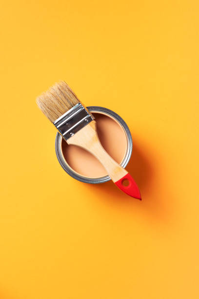 istock Brush and open paint can with on trendy yellow background. Top view, copy space. Appartment renovation, repair, building and home design concept. 1180991034