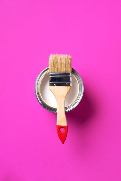 istock Brush and open paint can with on trendy yellow background. Top view, copy space. Appartment renovation, repair, building and home design concept. 1180991041