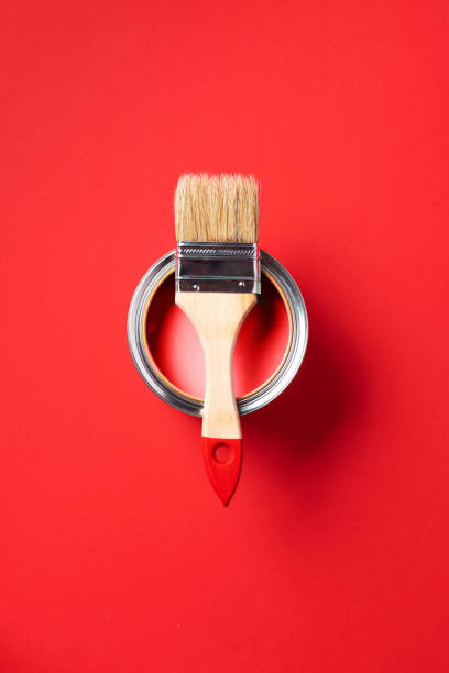 istock Brush and open paint can on trendy red background. Top view, copy space. Appartment renovation, repair, building and home design concept. 1180991071