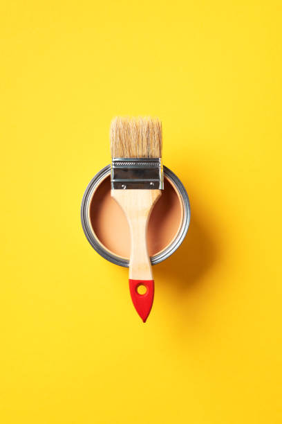 istock Brush and open paint can with on trendy yellow background. Top view, copy space. Appartment renovation, repair, building and home design concept. 1180991077