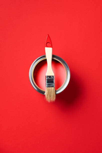 istock Brush and open paint can on trendy red background. Top view, copy space. Appartment renovation, repair, building and home design concept. 1180991086