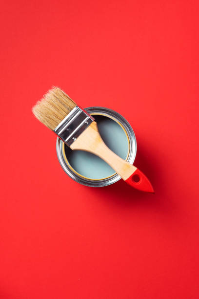 istock Brush and open paint can on trendy red background. Top view, copy space. Appartment renovation, repair, building and home design concept. 1180991096