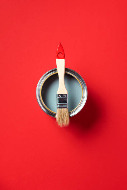 istock Brush and open paint can on trendy red background. Top view, copy space. Appartment renovation, repair, building and home design concept. 1180991100