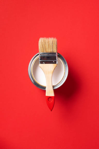 istock Brush and open paint can on trendy red background. Top view, copy space. Appartment renovation, repair, building and home design concept. 1180991104