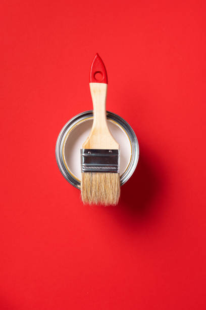 istock Brush and open paint can on trendy red background. Top view, copy space. Appartment renovation, repair, building and home design concept. 1180991106
