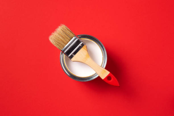 istock Brush and open paint can on trendy red background. Top view, copy space. Appartment renovation, repair, building and home design concept. 1180991125