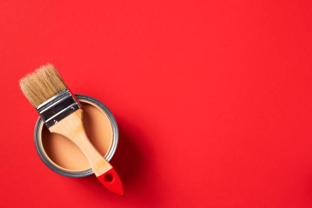 istock Brush and open paint can on trendy red background. Top view, copy space. Appartment renovation, repair, building and home design concept. 1180991129