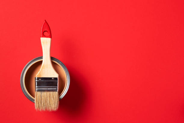istock Brush and open paint can on trendy red background. Top view, copy space. Appartment renovation, repair, building and home design concept. 1180991137