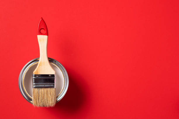 istock Brush and open paint can on trendy red background. Top view, copy space. Appartment renovation, repair, building and home design concept. 1180991139