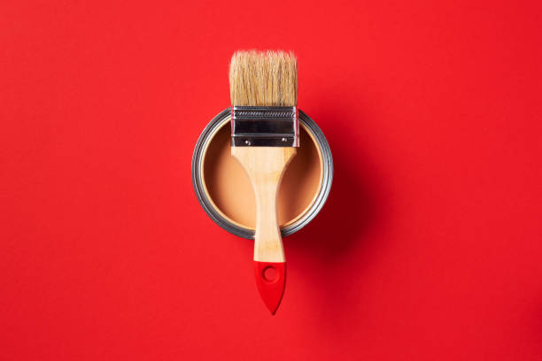 istock Brush and open paint can on trendy red background. Top view, copy space. Appartment renovation, repair, building and home design concept. 1180991145