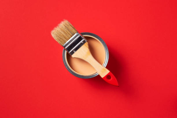 istock Brush and open paint can on trendy red background. Top view, copy space. Appartment renovation, repair, building and home design concept. 1180991157