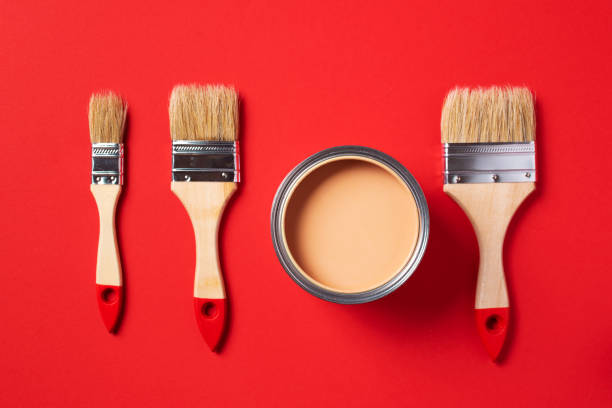 istock Brush and open paint can on trendy red background. Top view, copy space. Appartment renovation, repair, building and home design concept. 1180991179
