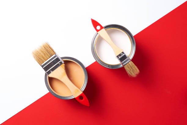 istock Wooden paint brushes, open paint cans on trendy red and white background. Top view, copy space. Appartment renovation, repair, building and home design concept. 1180991523