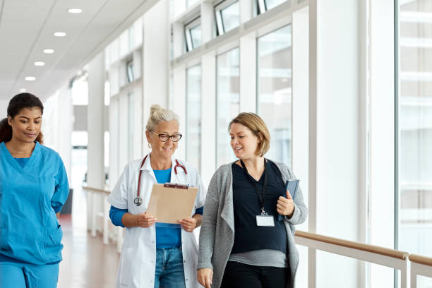 istock Smiling Doctors And Nurse In Hospital Corridor 1180992448
