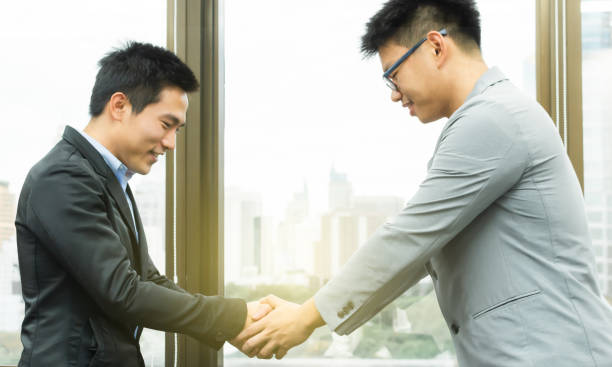 istock Business men is dealing business by shaking their hands 1180992479