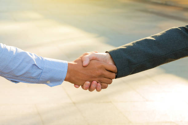 istock Business partnerchip concept. Two Business man making handshake together to agree joint business and partnership. 1180992612