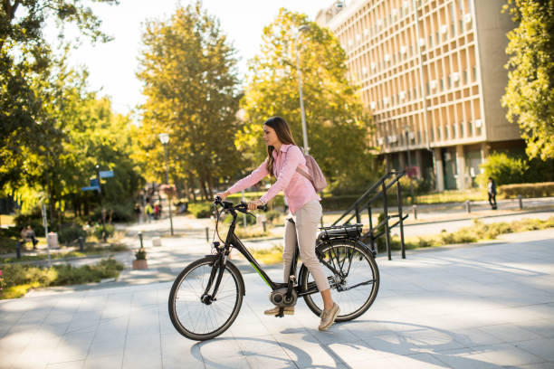 istock Young woman riding an electric bicycle 1180992695