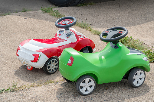 Modern children's plastic cars in the park
