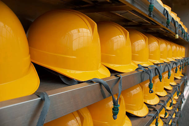 Bright Yellow Hardhats - closeup  strap stock pictures, royalty-free photos & images