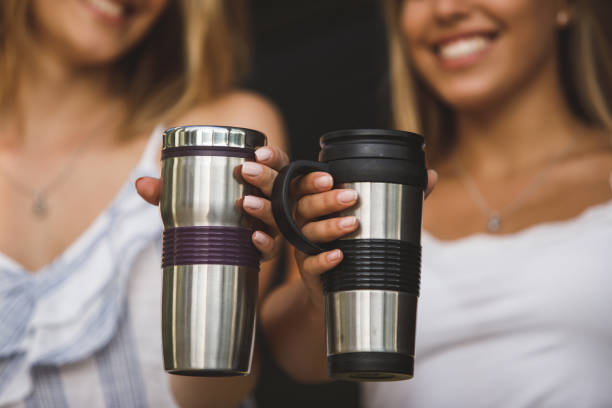 istock Showing off their travel coffee mugs 1180994641