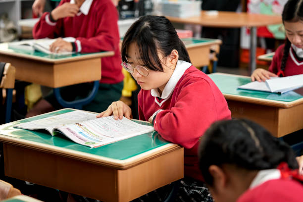 istock Teenage students studying in classroom at school 1180994875